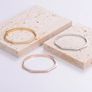 Octagonal stainless steel bangles with sparkling shell accents in gold, silver and rose gold