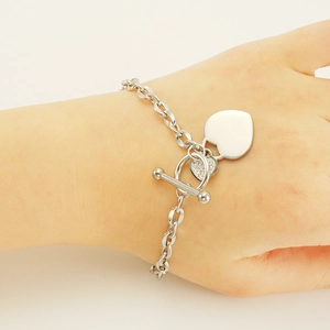 Vintage silver stainless steel double heart bracelet with OT toggle clasp on wrist