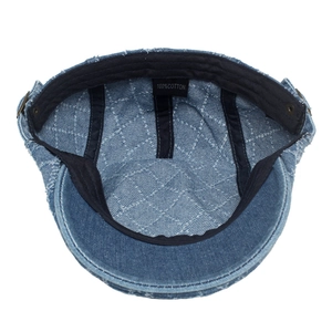 Detail of 100% cotton denim beret featuring quilted lattice stitching and inner label