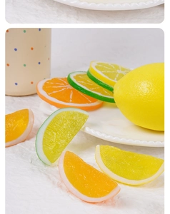 Close-up of realistic PVC artificial lemon and orange slices with detailed pulp textures