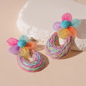 Handmade raffia flower earrings with colorful woven rainbow texture and steel pins