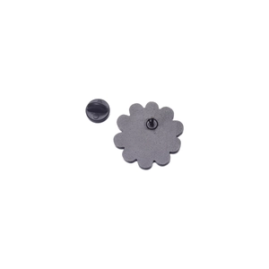 Minimalist enamel daisy flower badge with black rubber clasp on a clean white background