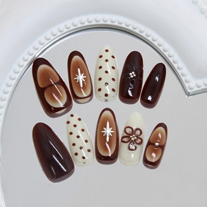 Vintage caramel and cream press-on nails with 3D floral and metallic star accents