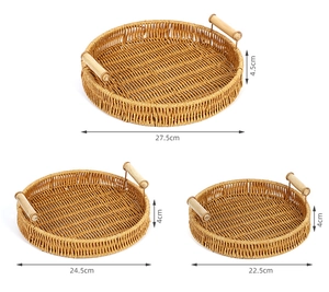 Set of three hand-woven fruit trays in various sizes with wooden handles for storage