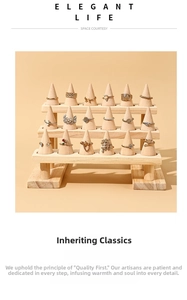 Three-tier wooden ring display stand with 18 varied gold and silver rings in soft lighting