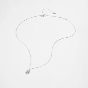 Close-up of S925 hallmark on silver necklace with hexagonal zircon pendant detail