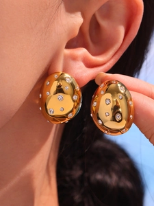 Detail view of oval 18k gold plated earrings with sparkling Czech rhinestones