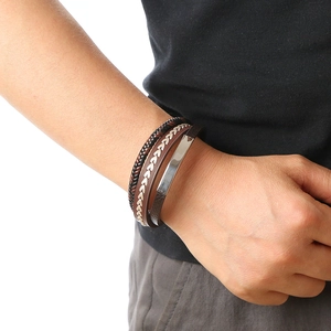Close-up of men's multi-layer braided leather bracelet with polished silver metal plate