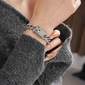 Close-up of sparkling silver Cuban chain bracelet with pavé diamonds and box clasp