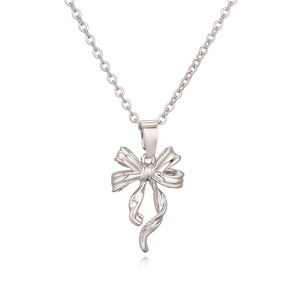 Minimalist silver bow pendant necklace for women with polished finish on white background