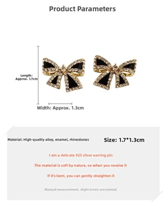 Detail of s925 silver needle bow earrings with black enamel and sparkling rhinestones