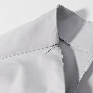 Detail of grey suit fabric texture with a high-quality invisible zipper and neat stitching