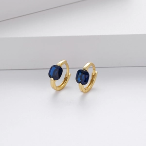 Detailed close-up of golden S925 silver hoop earrings with square blue zircon stones