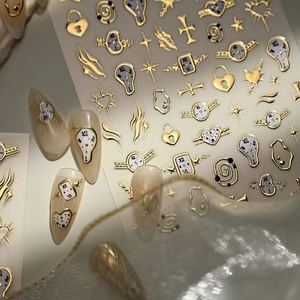 Luxury gold and silver nail stickers featuring surrealist melting clocks and stars