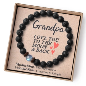 Close-up of volcanic rock grandpa bracelet set with moonstone and a meaningful gift card