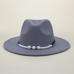 Close-up of elegant grey felt jazz hat with detailed pearl and gold beaded hatband