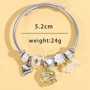 Silver stainless steel wire bracelet with heart and elephant charms on yellow background
