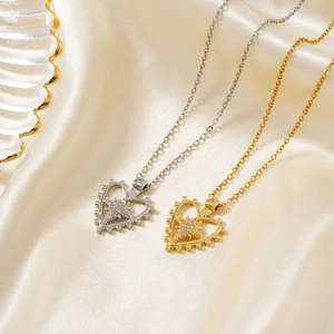 Elegant gold and silver heart star pendant necklaces on luxury silk fabric background