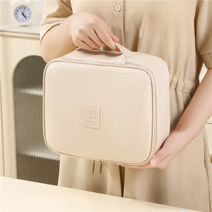 Large capacity cream PU leather travel makeup bag with handle and dual metal zippers