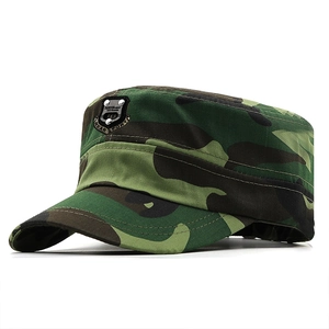 Detail of camouflage military flat top hat with metallic fashion sport badge on the front