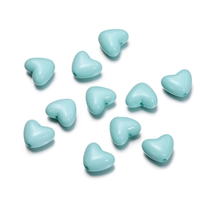 Macro shot of mint green heart-shaped acrylic beads for DIY jewelry and phone chains