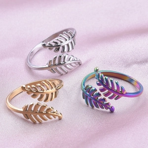 Adjustable leaf-shaped stainless steel rings in silver, gold, and rainbow finishes