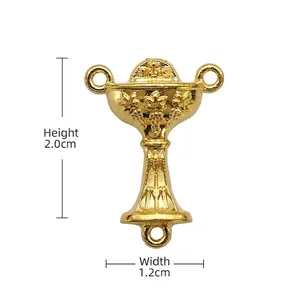 Detailed view of golden chalice rosary connector with IHS emblem and vine engravings