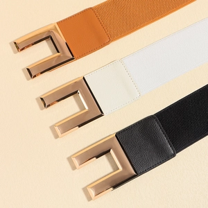 Three elastic waistbands in orange, white, and black with golden rectangle buckles