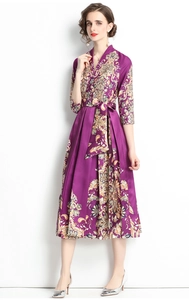 Macro shot of V-neck detail on the purple silk dress with bohemian floral patterns