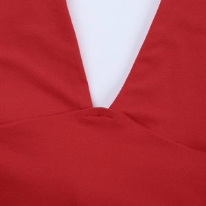 Detailed macro shot of the deep V-neckline stitching on a red knitted vacation dress