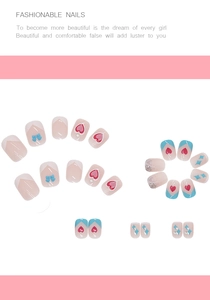 Detail of pink and blue press-on nails with 3D bows, hearts, and glitter patterns