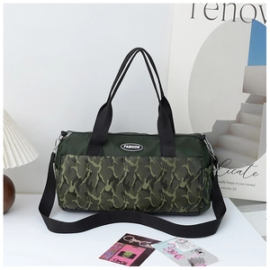 Macro detail of camouflage gym bag featuring dual handles and fashion logo patch
