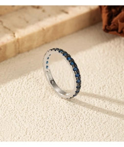 Macro detail of S925 sterling silver stamp and blue row diamonds on retro ring