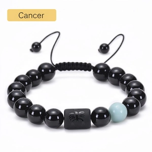 Detail of adjustable beaded Cancer zodiac bracelet with black onyx and tiger eye beads