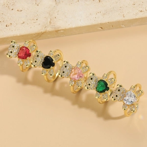 Golden bear rings set with colorful heart-shaped zircons in red, pink, and green