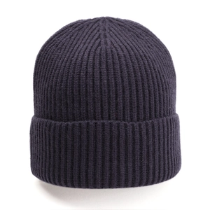 Detailed close-up of dark purple ribbed knit beanie showing thick texture and folded cuff