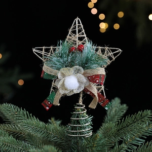 Golden iron wire Christmas tree topper star with festive red berries and ribbon