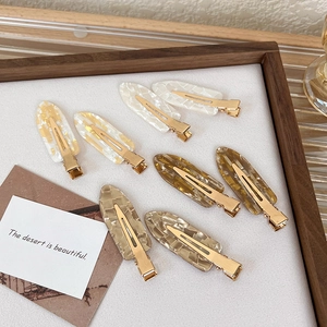 Set of 8 seamless marble pattern hair clips in neutral tones with gold metal base