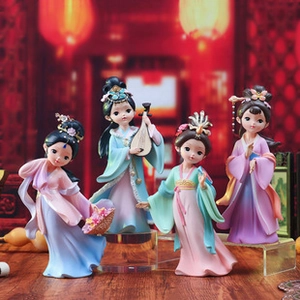 Detail of four colorful Chinese Tang dynasty style resin lady figurines on a wooden table
