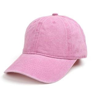 Detail of vintage washed pink cotton baseball cap with curved brim and reinforced stitching