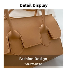 Detail shot of light brown leather handbag showing premium stitching and handle attachment
