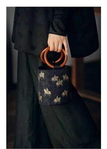 Detail of wooden ring handles and horse pattern jacquard on this retro bucket bag
