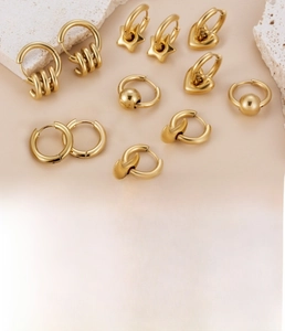 Detailed view of gold plated titanium steel earring set with heart star and moon shapes
