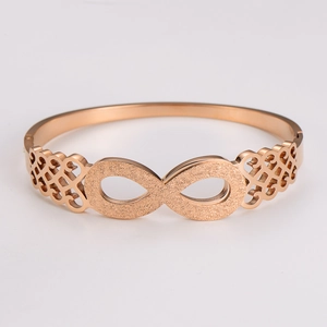 Detailed macro of rose gold infinity bracelet with matte finish and hollow patterns