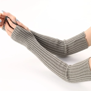 Detail of grey knitted arm warmers with ribbed texture and thumb holes for women