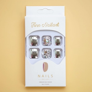 Detailed view of silver mirror toenails with rhinestone accents in display packaging