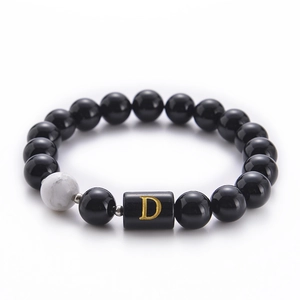 Detail of 10mm black onyx and white turquoise bead bracelet with gold D letter bead