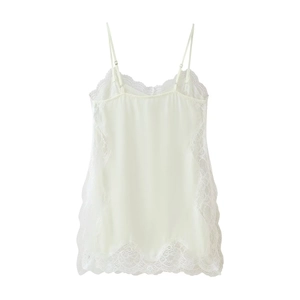 Close-up detail of cream silk camisole with delicate floral lace panels and adjustable straps