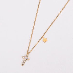 Detailed macro of 18k gold plated necklace with rhinestone cross and star pendants