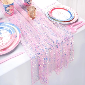 Macro detail of sparkling pink sequin table runner on white table in party scene
